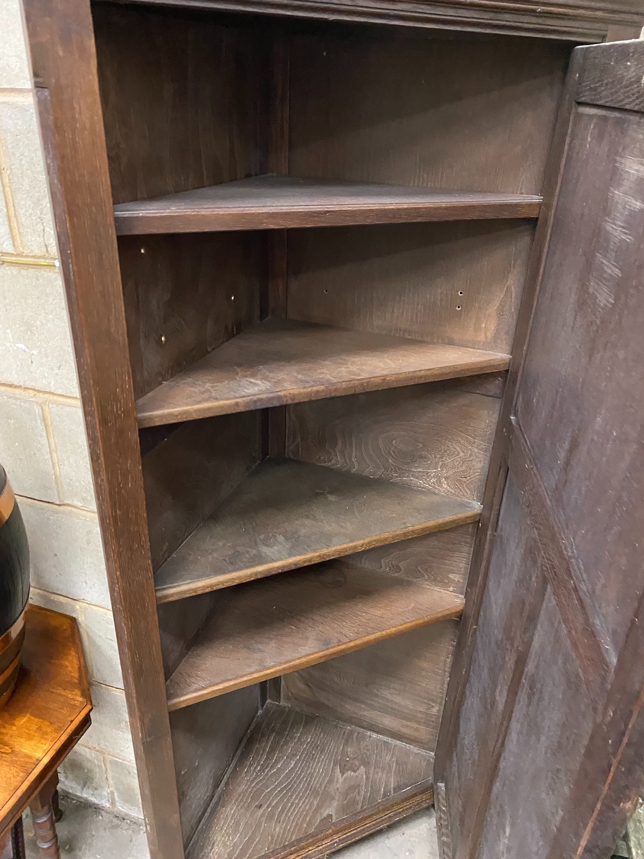 A 17th century style oak linenfold moulded standing corner cabinet, width 83cm, depth 45cm, height 180cm